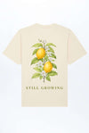 Beiges relaxed Heavy T-Shirt mit Zitronen-Print vorn „STILL GROWING“