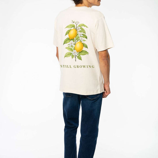 Beiges relaxed Heavy T-Shirt mit Zitronen-Print hinten „STILL GROWING“