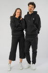 U-STSU856-Boxy-Hoodie-aus-Bio-Baumwolle-Bio-Baumwolle-Kleidung-Unisex-SAIGA-Black-Vorne5